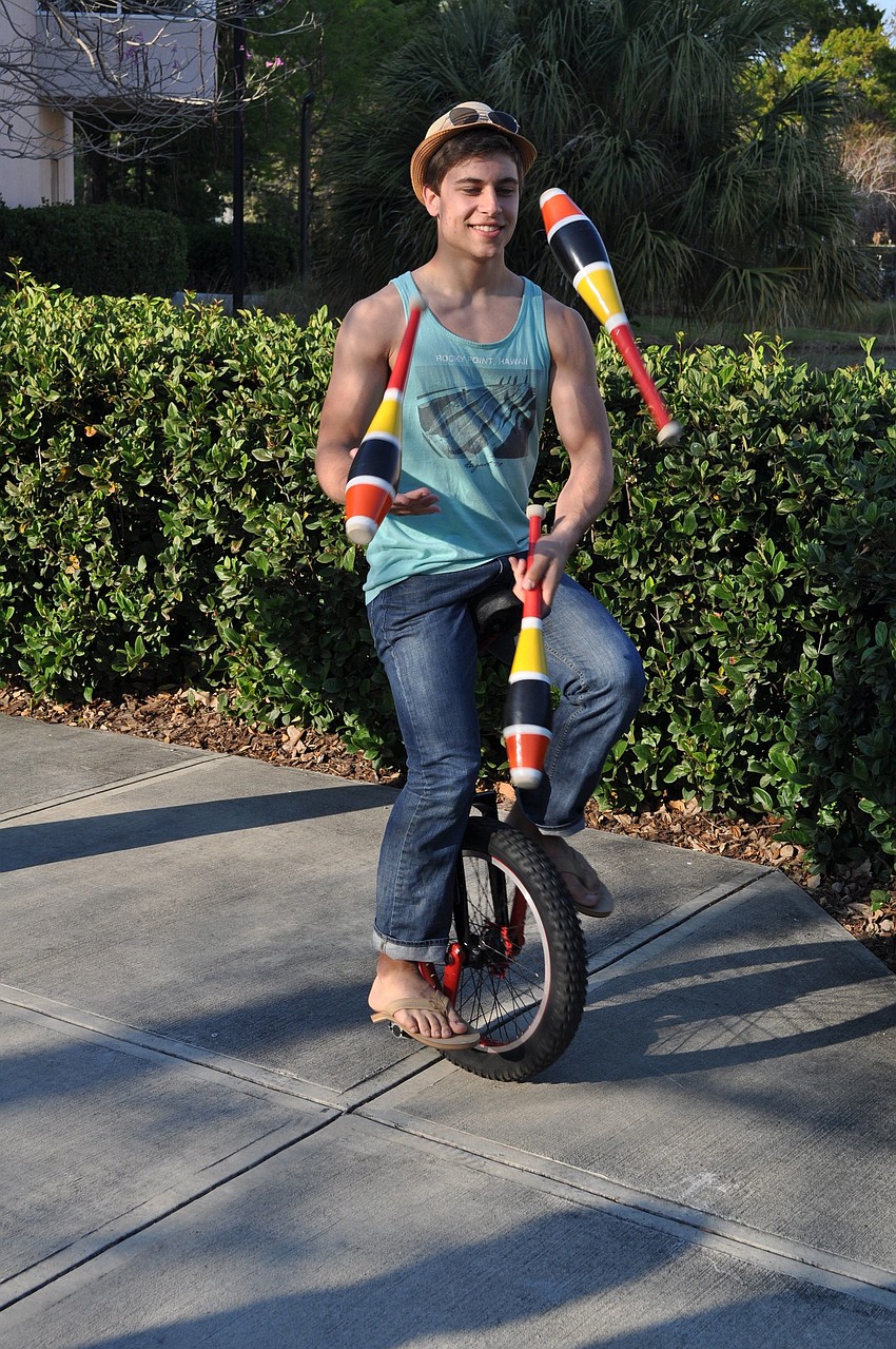 Nick Slimick, 17, rides a unicycle while juggling.