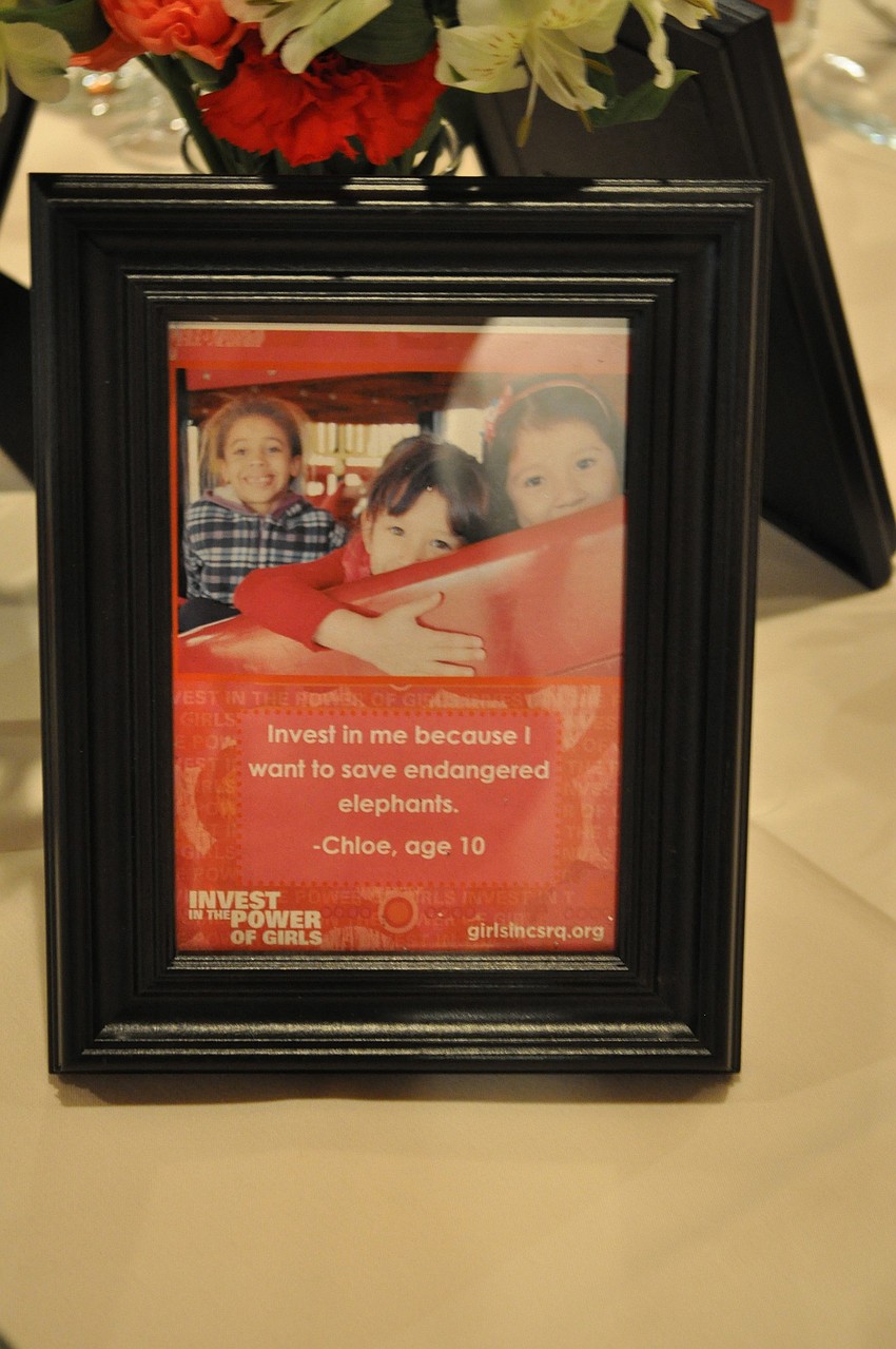 There were various photos and quotes about Girls Inc on each table.