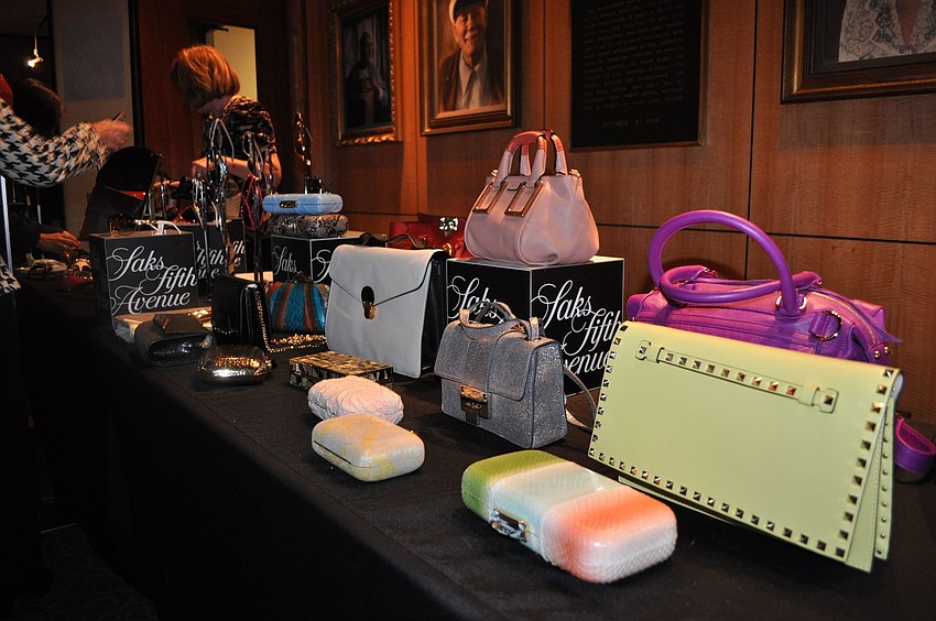 A table full of clutches, purses, sunglasses and other fun accessories from Saks Fifth Avenue.