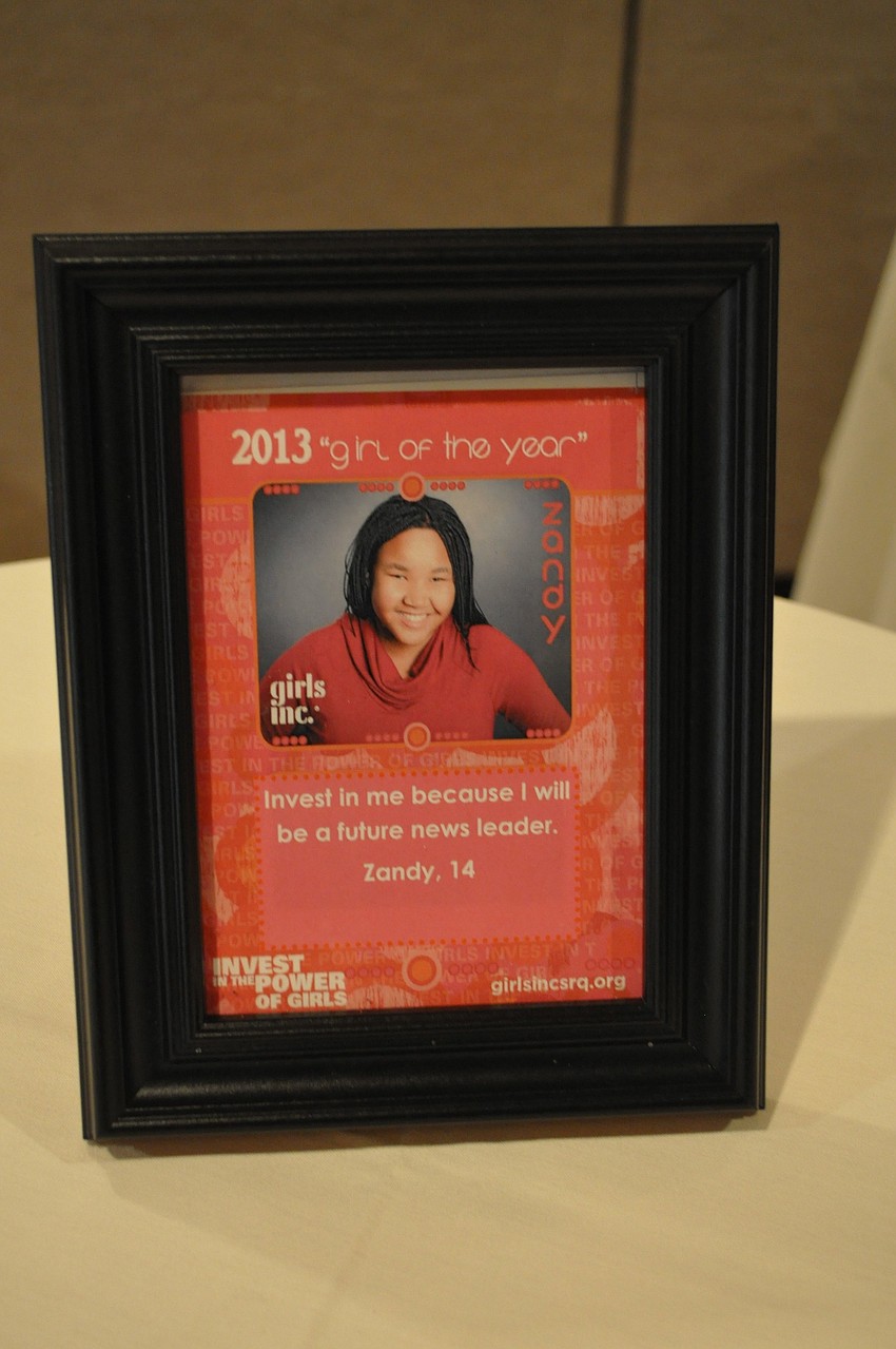 A framed photo and quote from the 2013 Girl of the Year Zandy Sanders.