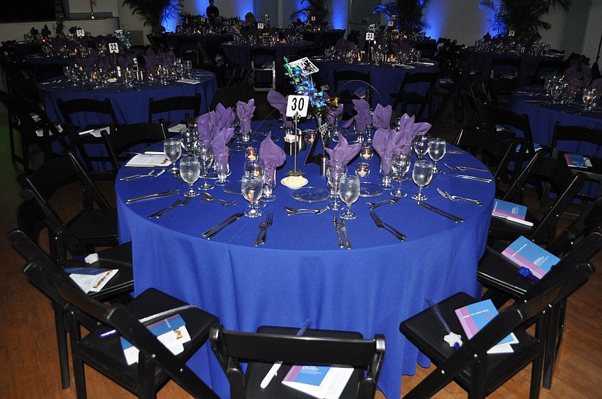 The tables were decorated with blue table clothes, purple napkins and blue and white orchids.