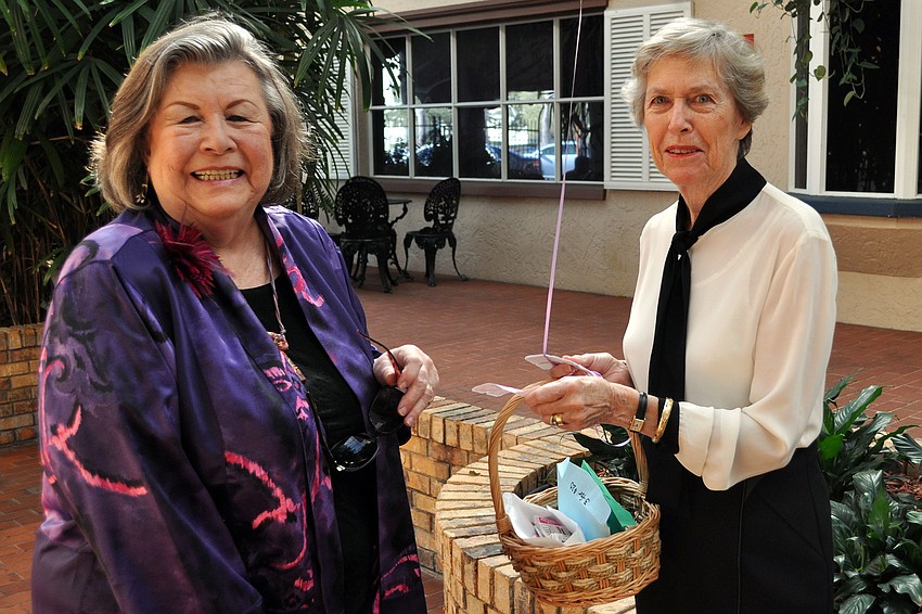 Anne Howard buys some raffle tickets from Sally Scott