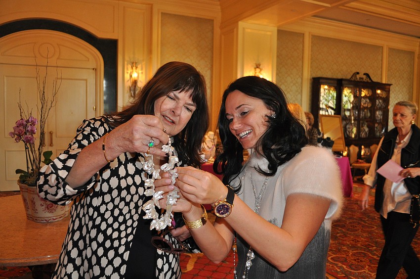 Patricia Johnson talks with jewelry designer Liliya Kent about one of her pieces.