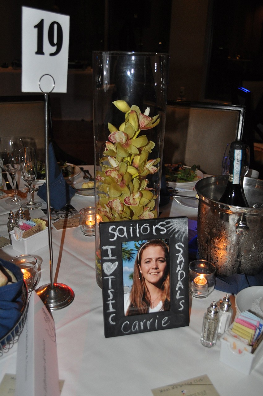 Seniors from area schools that won scholarships from Take Stock in Children were in decorated frames at each table.