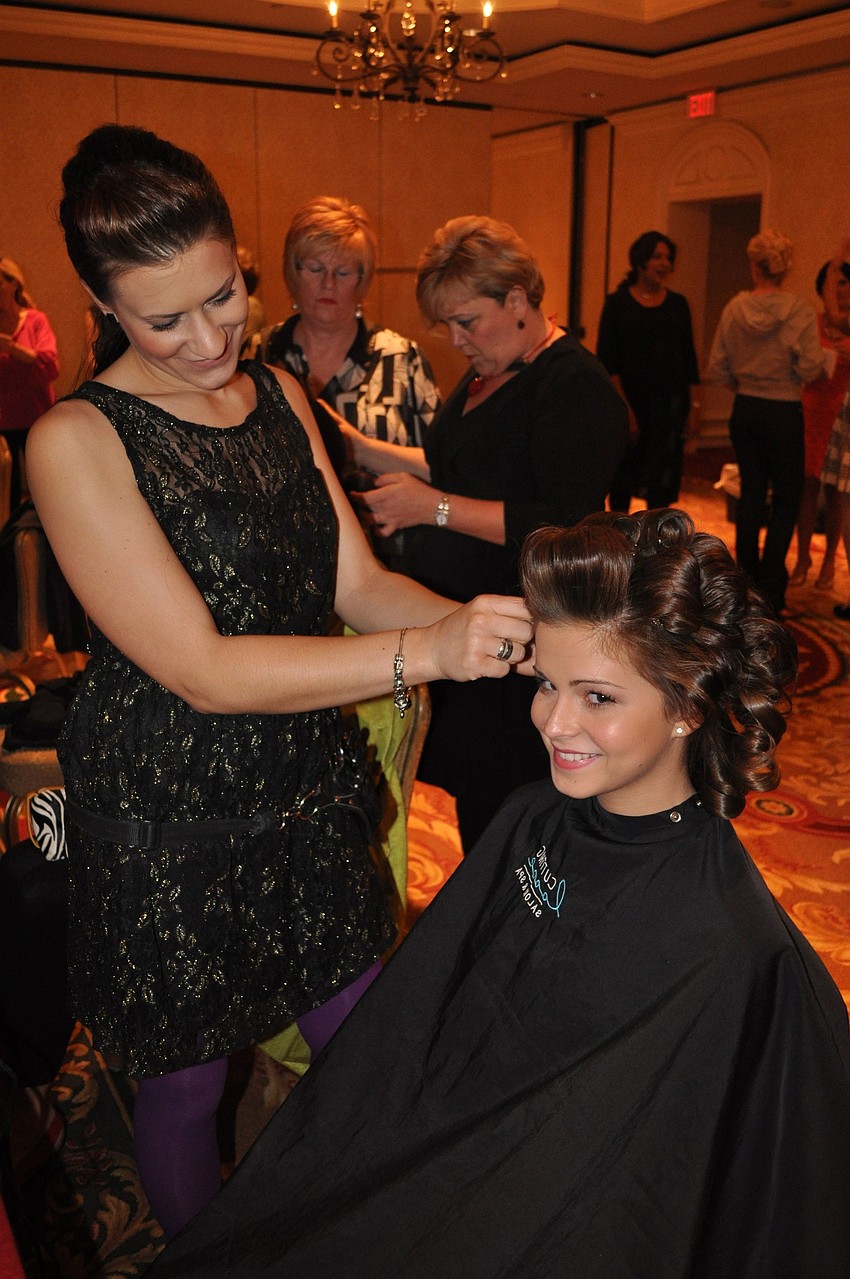 Julie Ann Dombeck works on Lauren Ponzoâ€™s hair.