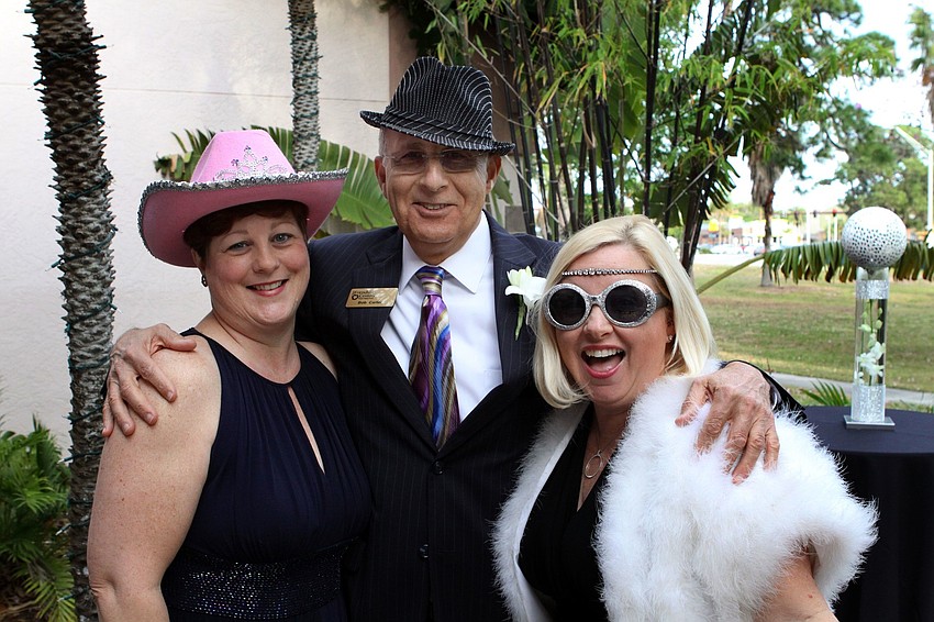 Sue Firestone, Bob Carter and Erin McLeod get ready to have some fun in the photo booth.