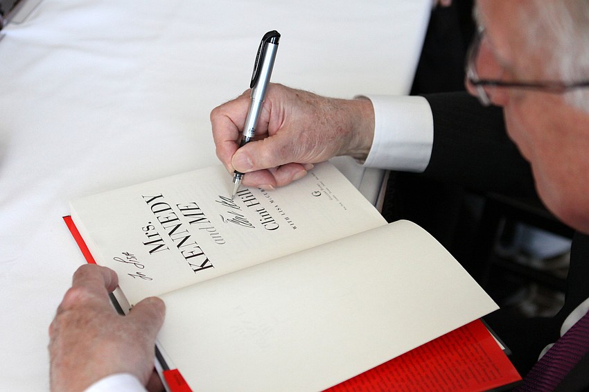 Clint Hill signs his name.