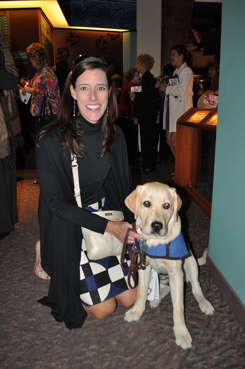 Meisha Wilson with her training guide dog puppy, Cory.