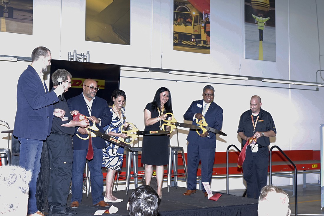 DHL executives, accompanied by Tampa and Florida leaders and officials, cut the ribbon on the company&#39;s new service center this week. Courtesy photo.