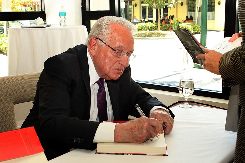 Clint Hill signing books.