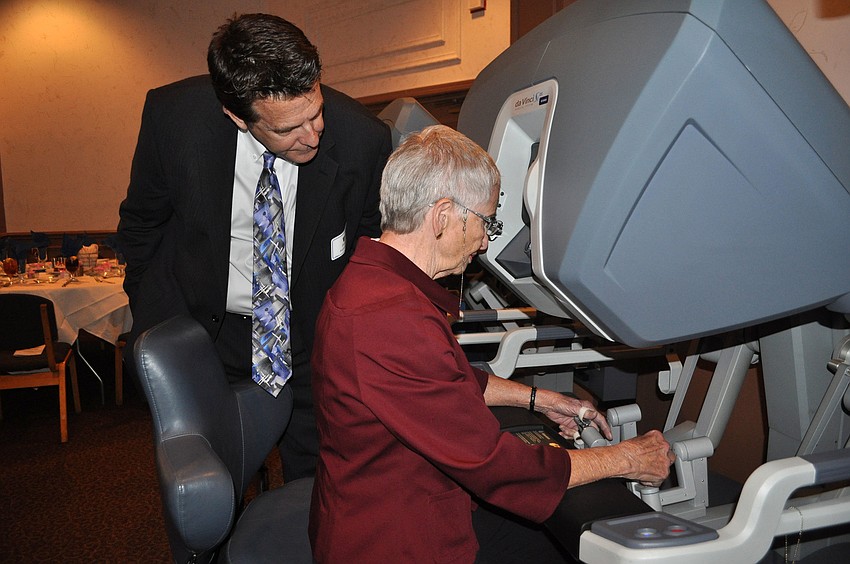 David Patterson helps Ruth Dimlich with the DaVinci machine