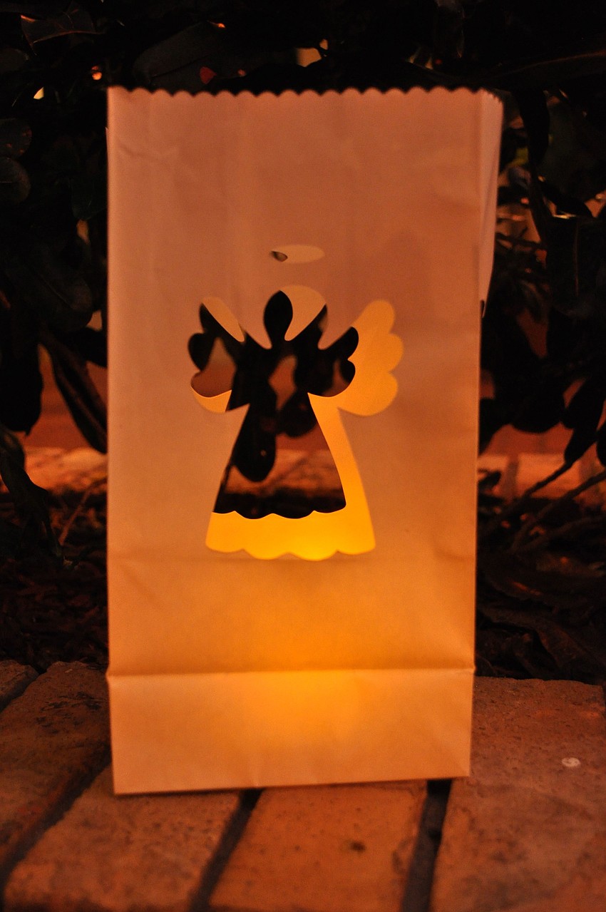 The courtyard was illuminated with paper lanterns with a cutout of an angel with a small tea light inside.