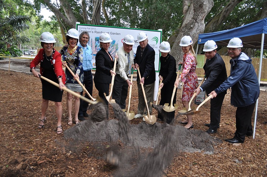 The group throws a bunch of dirt during the reception and ceremony celebrating the Selby Gardens Childrenâ€™s Rainforest Garden.