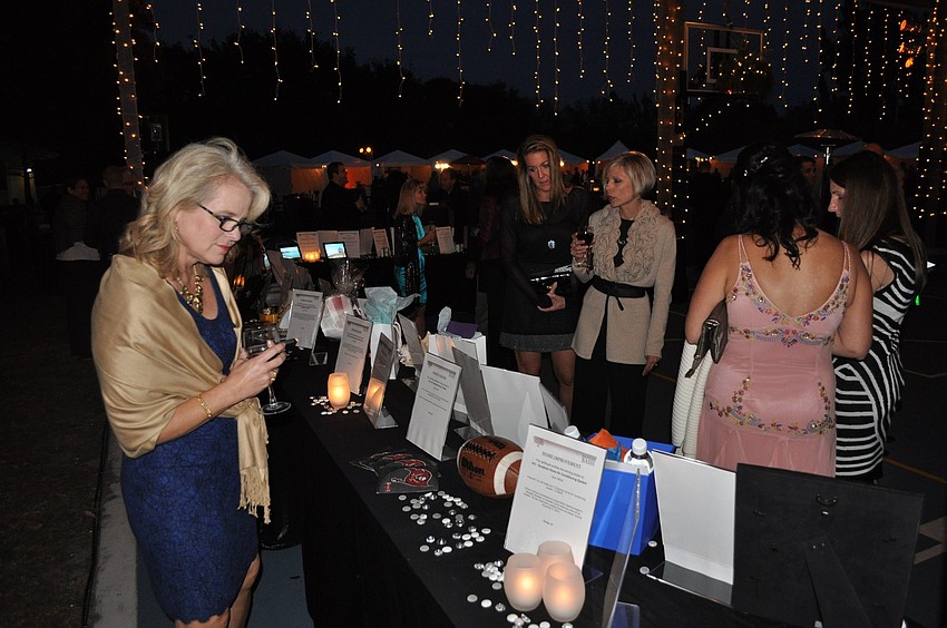 People check out the items at the silent auction tables.