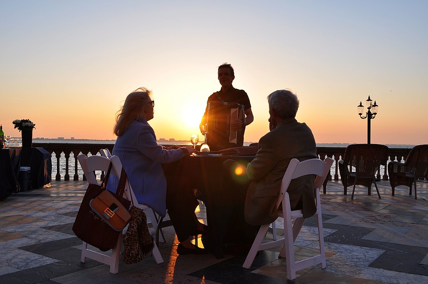 Bob Knight sings and plays the accordion for George and Pam Campbell.