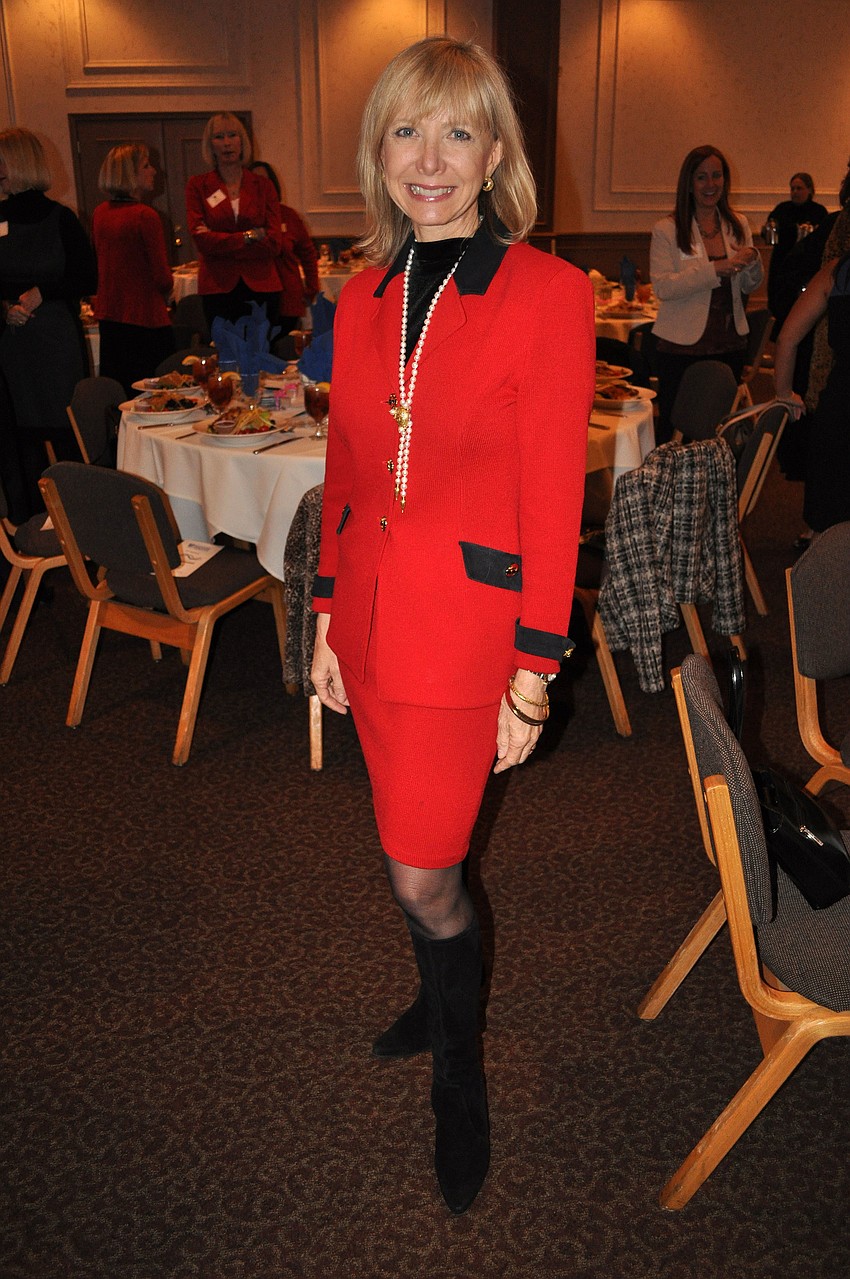 Charlie Ann Syprett wore a red St. Johnâ€™s suit with Stuart Weitzman boots