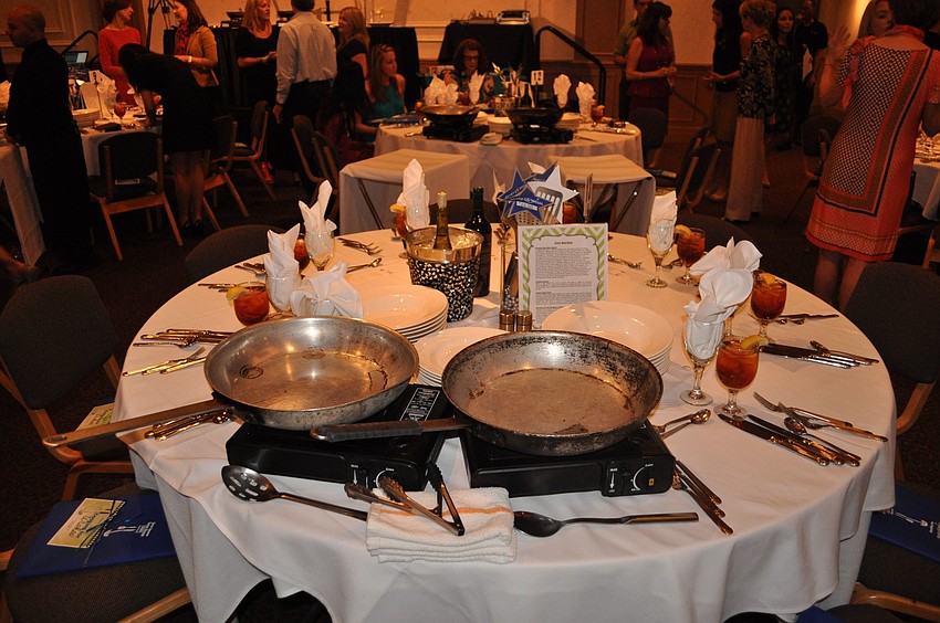Each table was set up with two gas-stove tops, plates and wine.