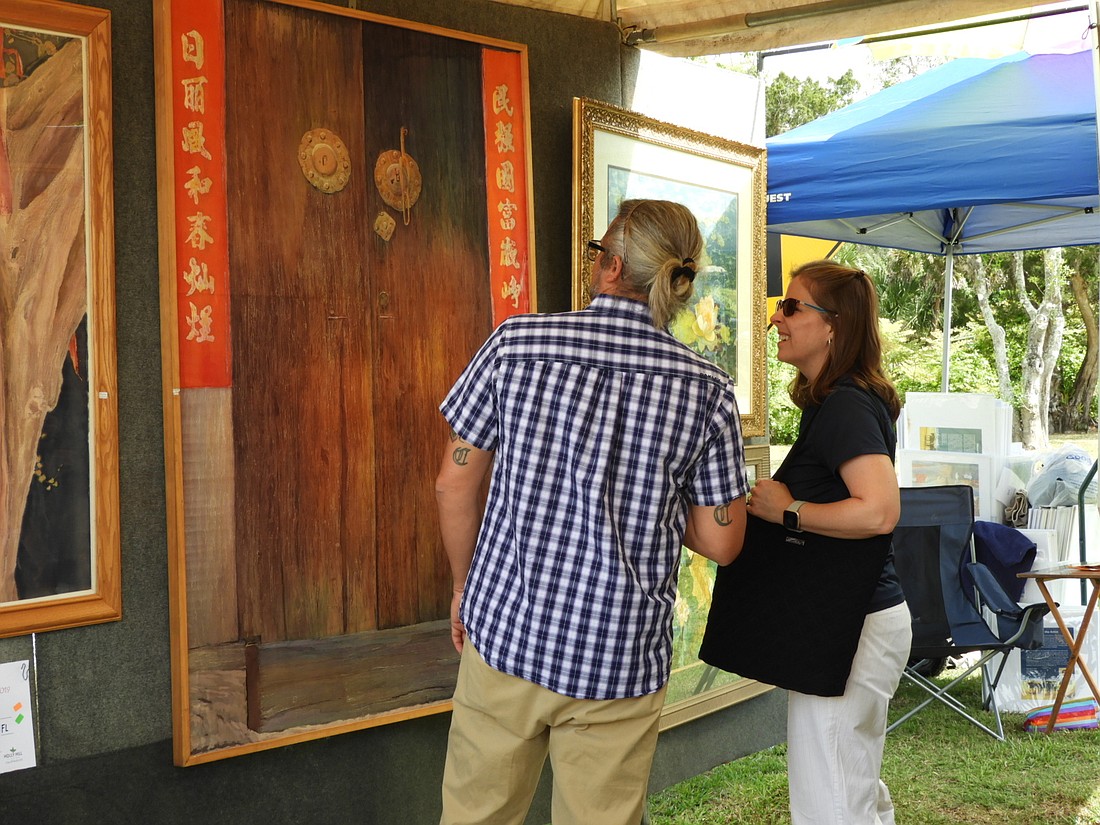 People look at art during a previous Holly Hill Art Festival. Courtesy photo
