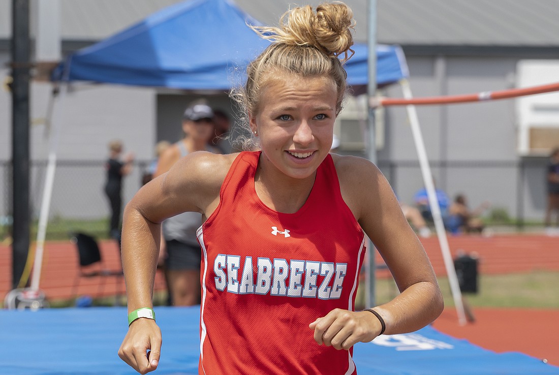 Kimberly Collins smiles after a successful high jump at regionals. Photos by Michele Meyers
