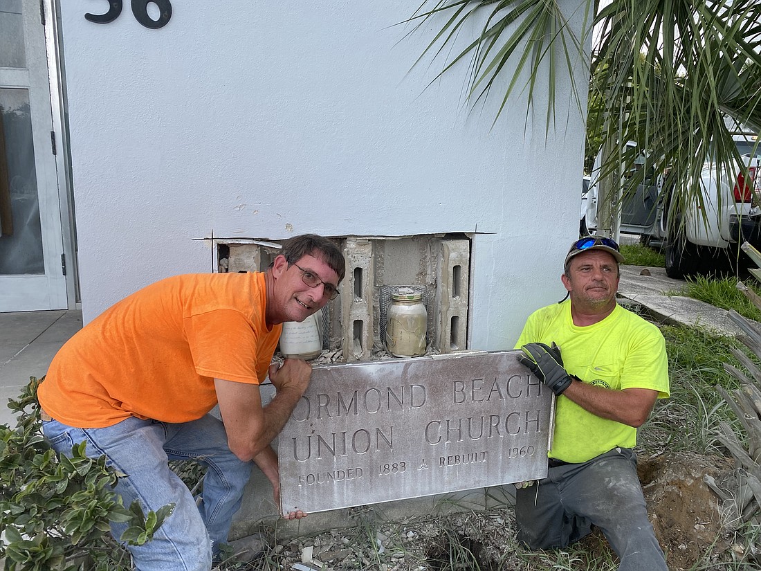 Ed Wilson and Bill Treptow remove the church's cornerstone, revealing two time capsules. Courtesy of the city of Ormond Beach