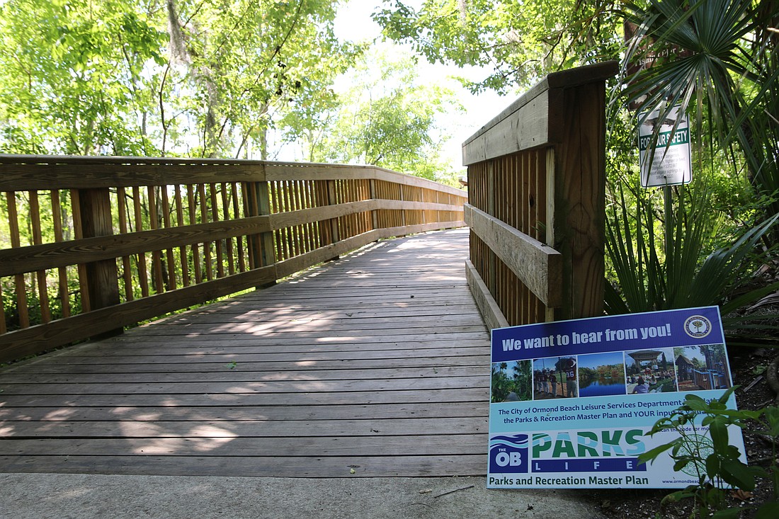 A sign sits on a boardwalk located inside Central Park in Ormond Beach. File photo