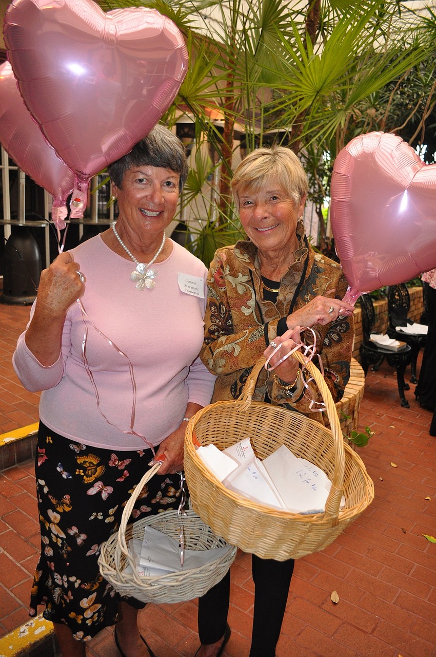 Connie Mereness and Beverly Parker sold raffle tickets in the courtyard of Michaelâ€™s On East.