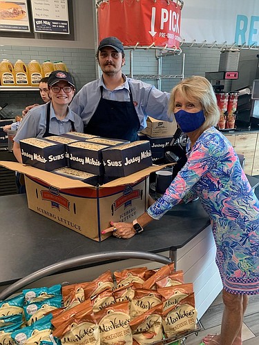 FBH Executive Director Judi Winch picks up sub meals from Andre Dahlen and Amanda Aucoin at Jersey Mike's Subs. Courtesy photo