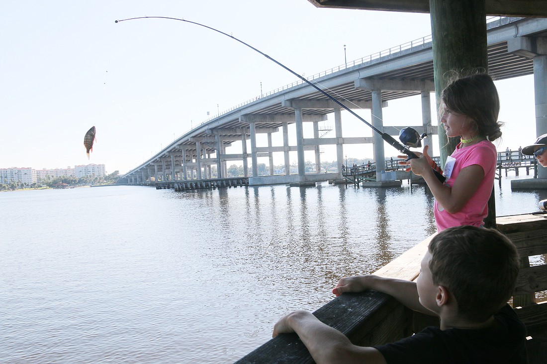 Emily Arbiso catches a fish during the Reel in the Fun kids fishing tournament at Bailey Riverbridge Gardens in 2019. File photo