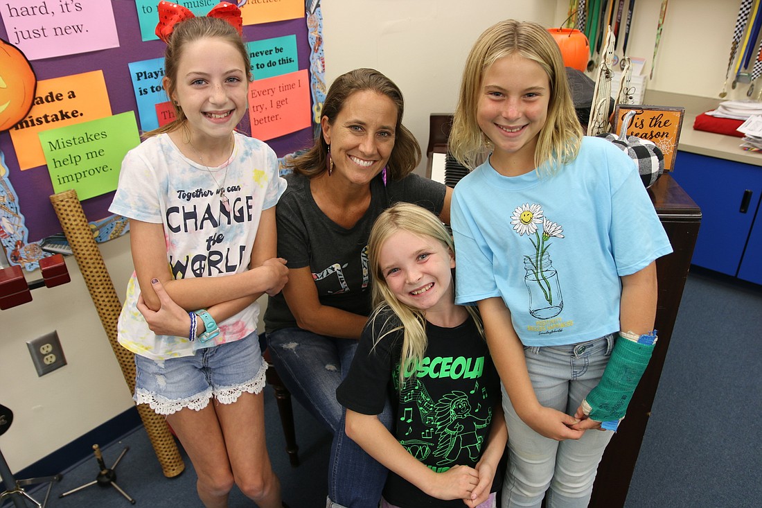 Beachside Elementary fifth grader Natalie Ambrosio, music teacher Sarah Johns, and fifth graders Stella Taylor and Tracey Spruill. Photo by Jarleene Almenas