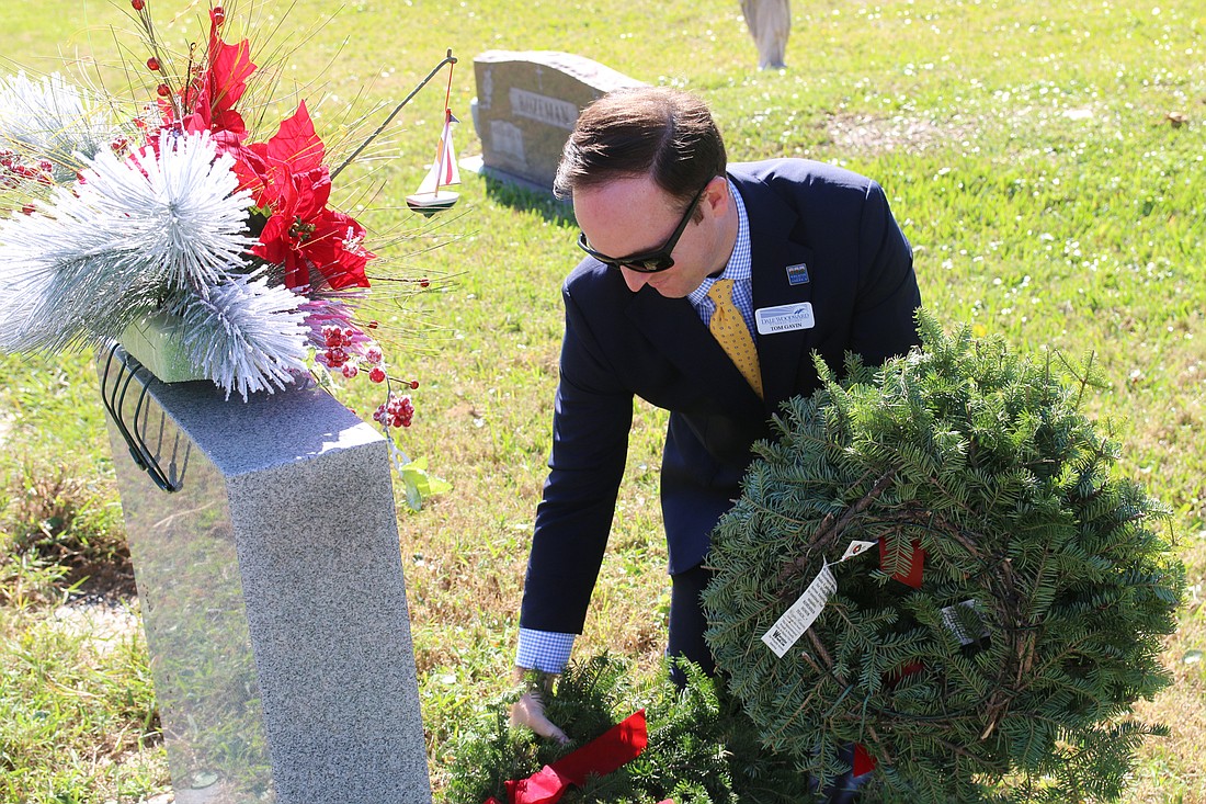 Tom Gavin lays a ceremonial wreath on a veteran's grave during 2019's Wreaths Across America service at Hillside Cemetery on Saturday, Dec. 14. File photo