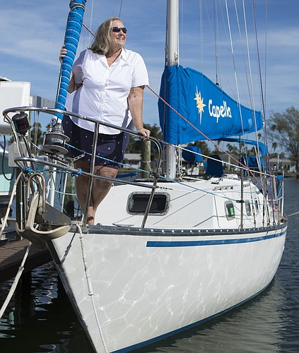 Mark Wemple. Kris Self aboard Capella, her 33-foot sailboat.