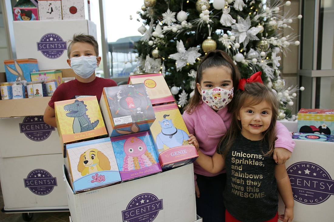 Gavin, 7, Kendall, 6 and Ivory, 2, showcase some of the Scentsy buddies before they are distributed to children at AdventHealth Daytona Beach. Photo by Jarleene Almenas