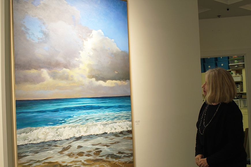 Kate MacDonald admires "Caribbean Light at Turks and Caicos" by Stephen Estrada at the Ormond Memorial Art Museum during the 29th-annual "Starry Starry Night" gallery walk in 2018. File photo