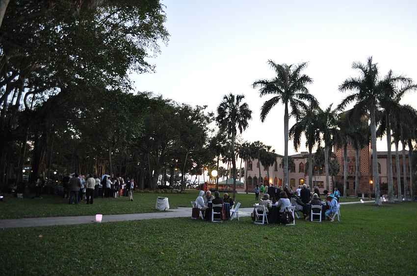 People dine on the lawn of the Caâ€™ dâ€™Zan at the Wine Walk to the Caâ€™ dâ€™Zan.