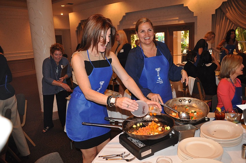 Renee Phinney and Rebecca Blitz have some laughs while cooking.