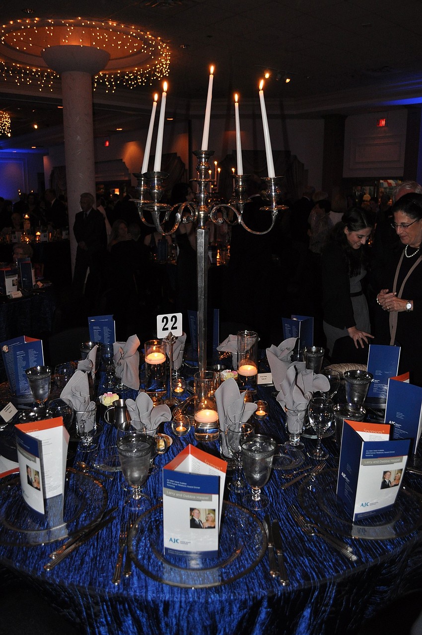 The tables were decorated with sapphire table clothes and either large candelabras or vases with flowers.