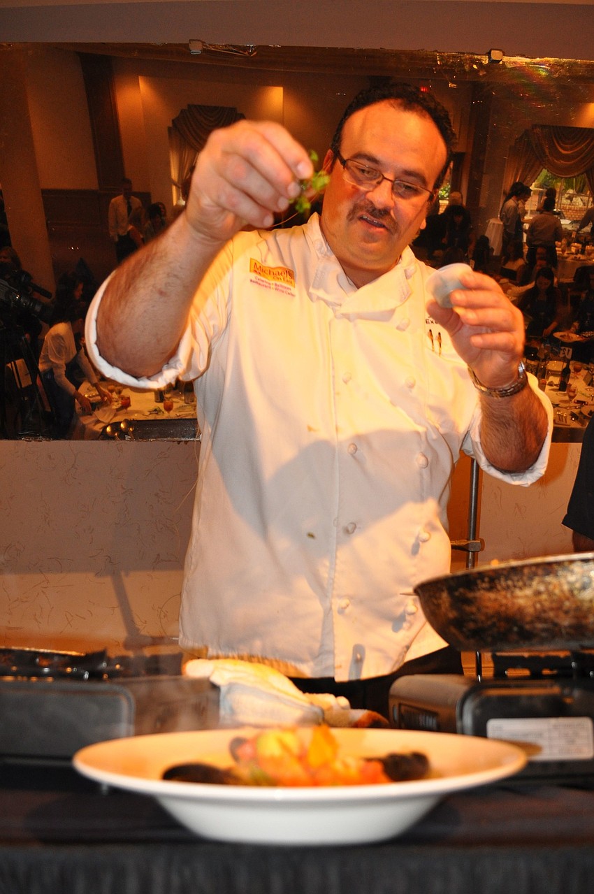 Executive Chef Jamil Pineda shows the audience how to add some final touches to their plated dish.