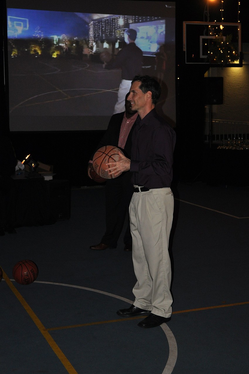 Doug Morgan tries to shoot a half court shot to win free tuition for a year.