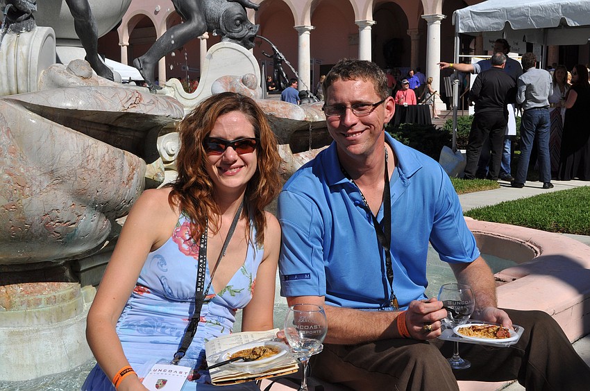 Julie and Bryan Simonson enjoy some food and wine by the fountain in the courtyard.