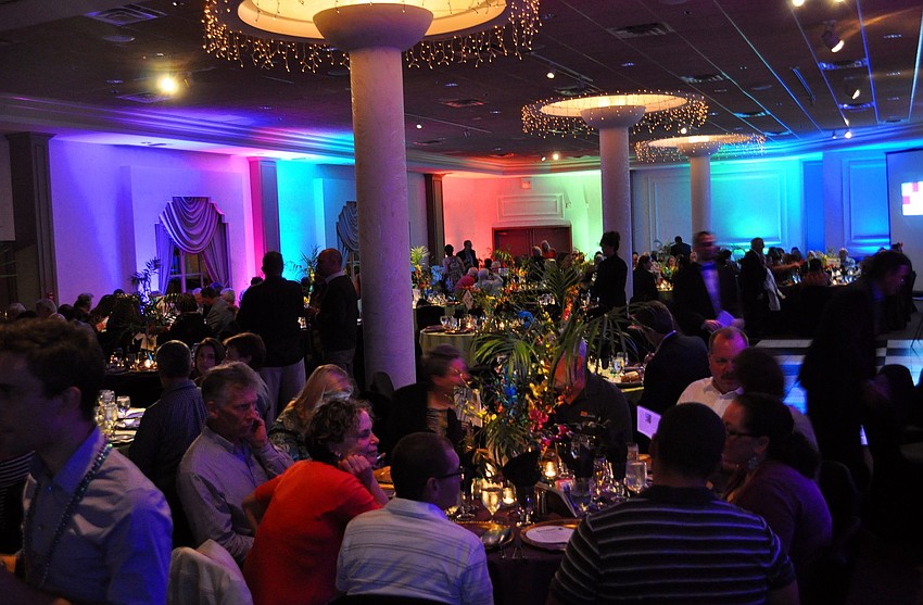 The ballroom was lit with blue, red, green, pink and purple lighting making the room festive for the Mardi Gras theme.