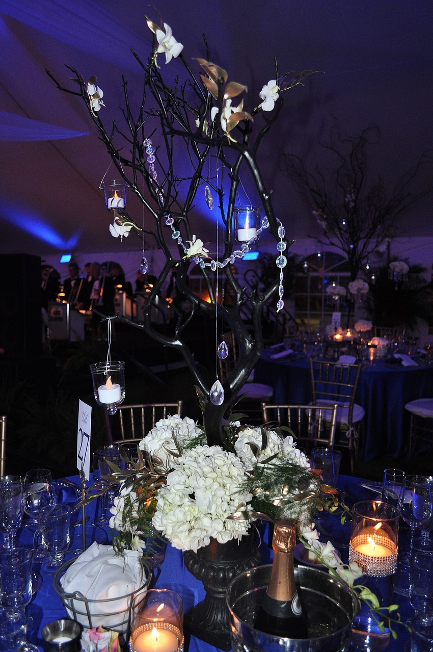 The centerpieces were arranged by Flowers by Fudgie.