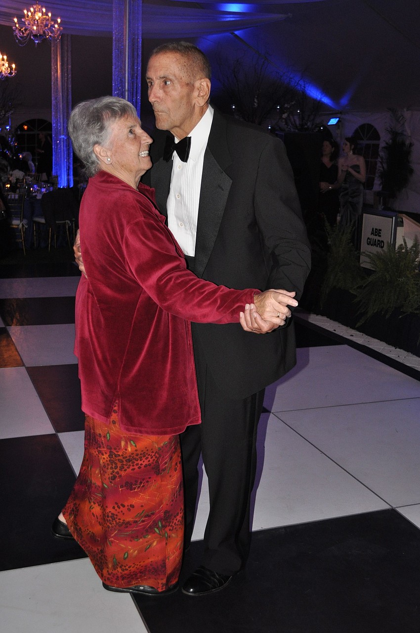 Anne and Cope Garrett dance together on the dance floor.
