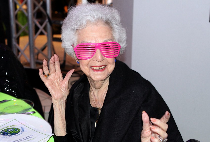 Ruth Resnick has some fun with glasses at her table.