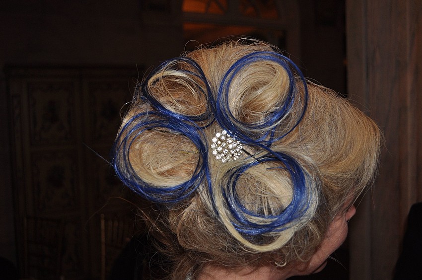 Tricia Hopkins has her hair done up in the â€œfour windsâ€, the New College symbol, for the inaugural ball.