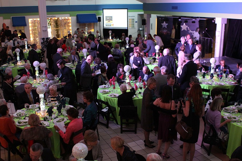 People mingle with one another at the Madcap Evening event.