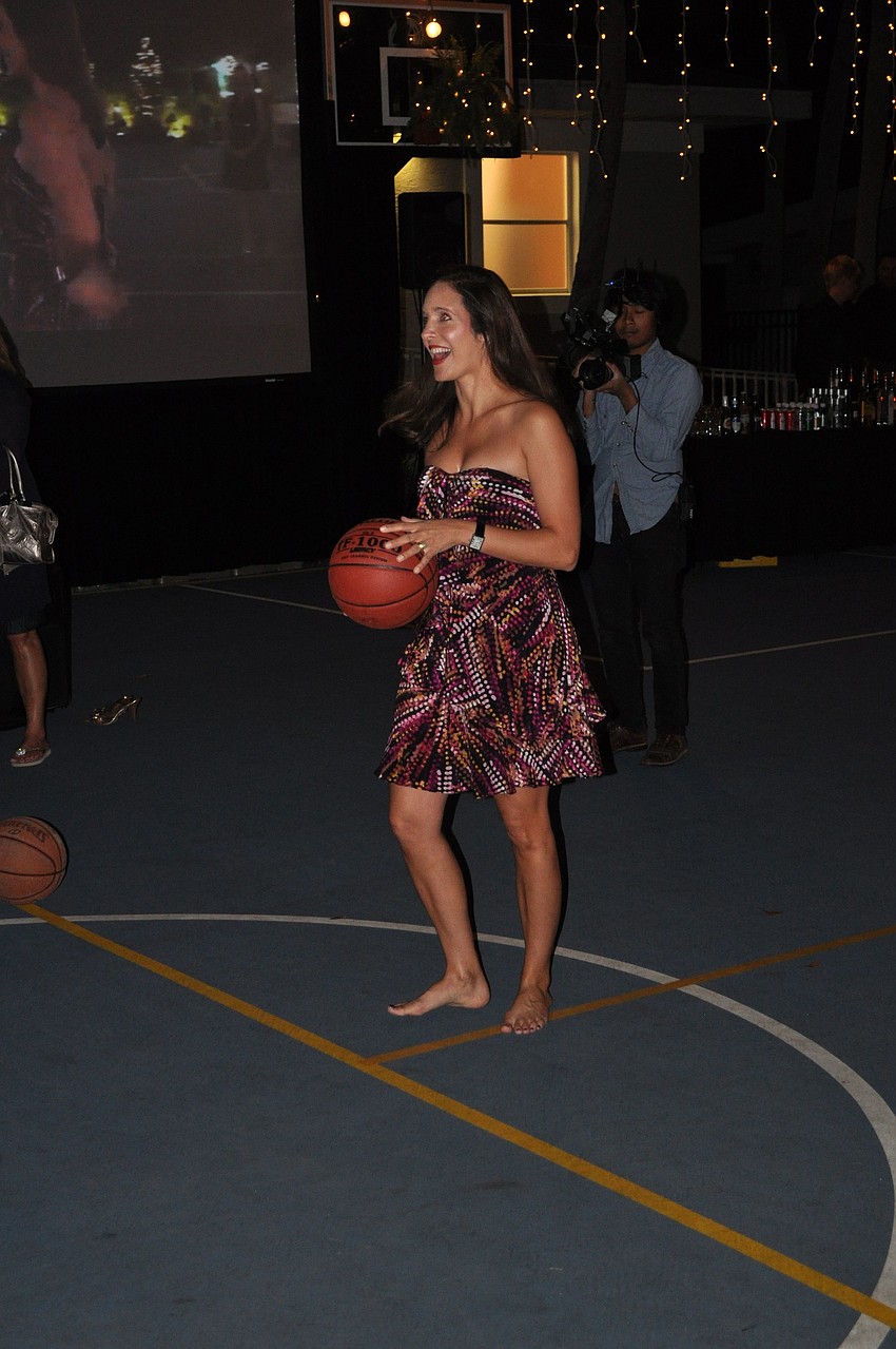 Jennie Famiglio tries to win a free year of tuition by shooting a half-court shot.