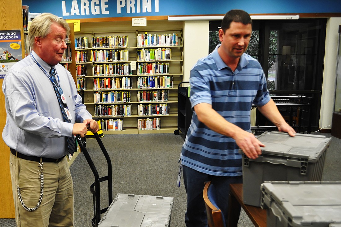 Gulf Gate Library Manager Jim Mitchell and teen coordinator Robert Vaura pack library supplies Friday, Jan. 18 in anticipation of the move to Westfield Sarasota Square Mall.