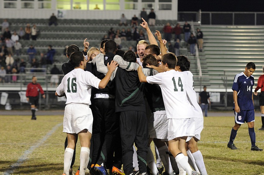 The Lakewood Ranch High boys soccer team celebrates following its 2-1 victory over Manatee in the Class 4A-District 11 championship Jan. 25.