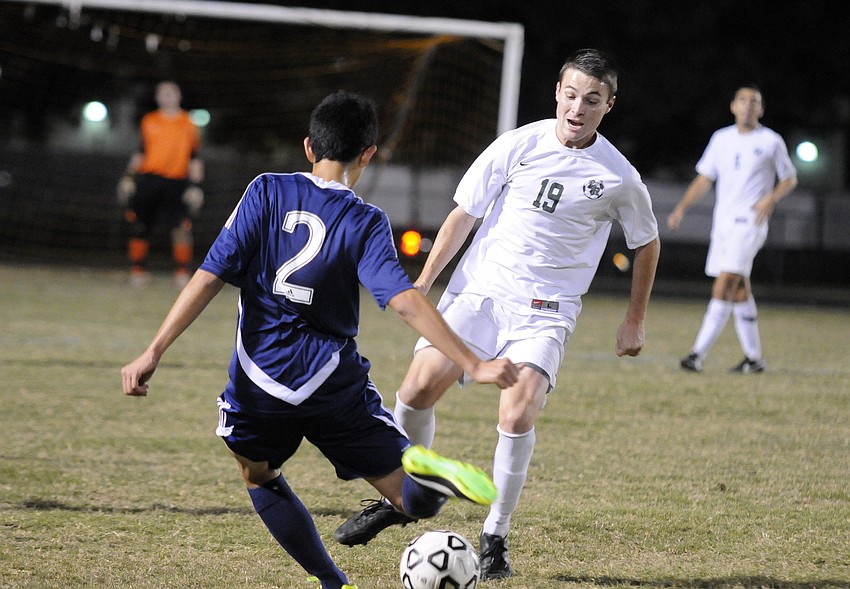 Lakewood Ranch midfielder Ian Nolan looks to keep Manatee from moving the ball up field.