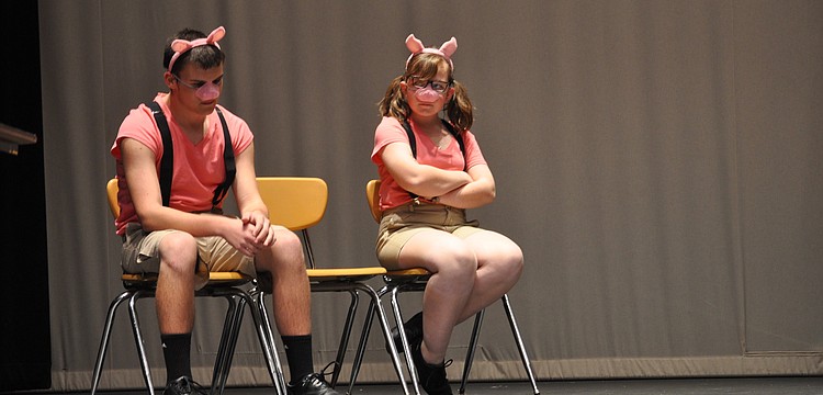 Matthew Kenner, as Benny the pig and Emily Gartenberg, playing Jenny the pig, sat alone as the Wicked Witch went to trial.